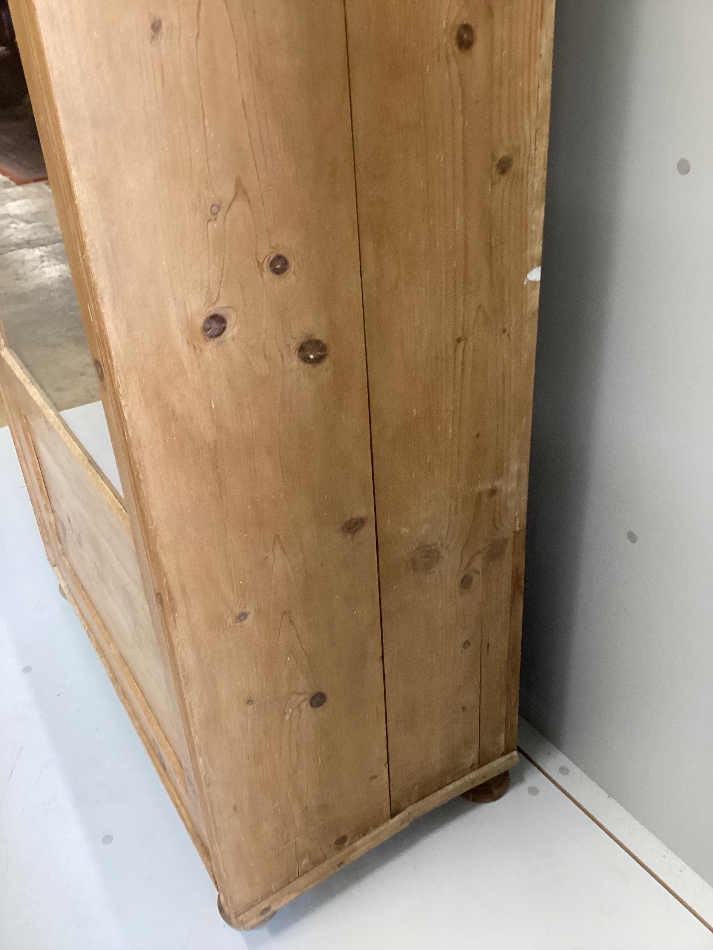 A 19th century East European glazed pine cabinet, width 95cm, depth 49cm, height 184cm
